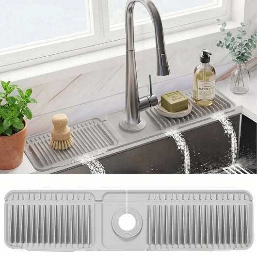 Gray Faucet Drain Mat behind a kitchen faucet, splashes running back into the sink